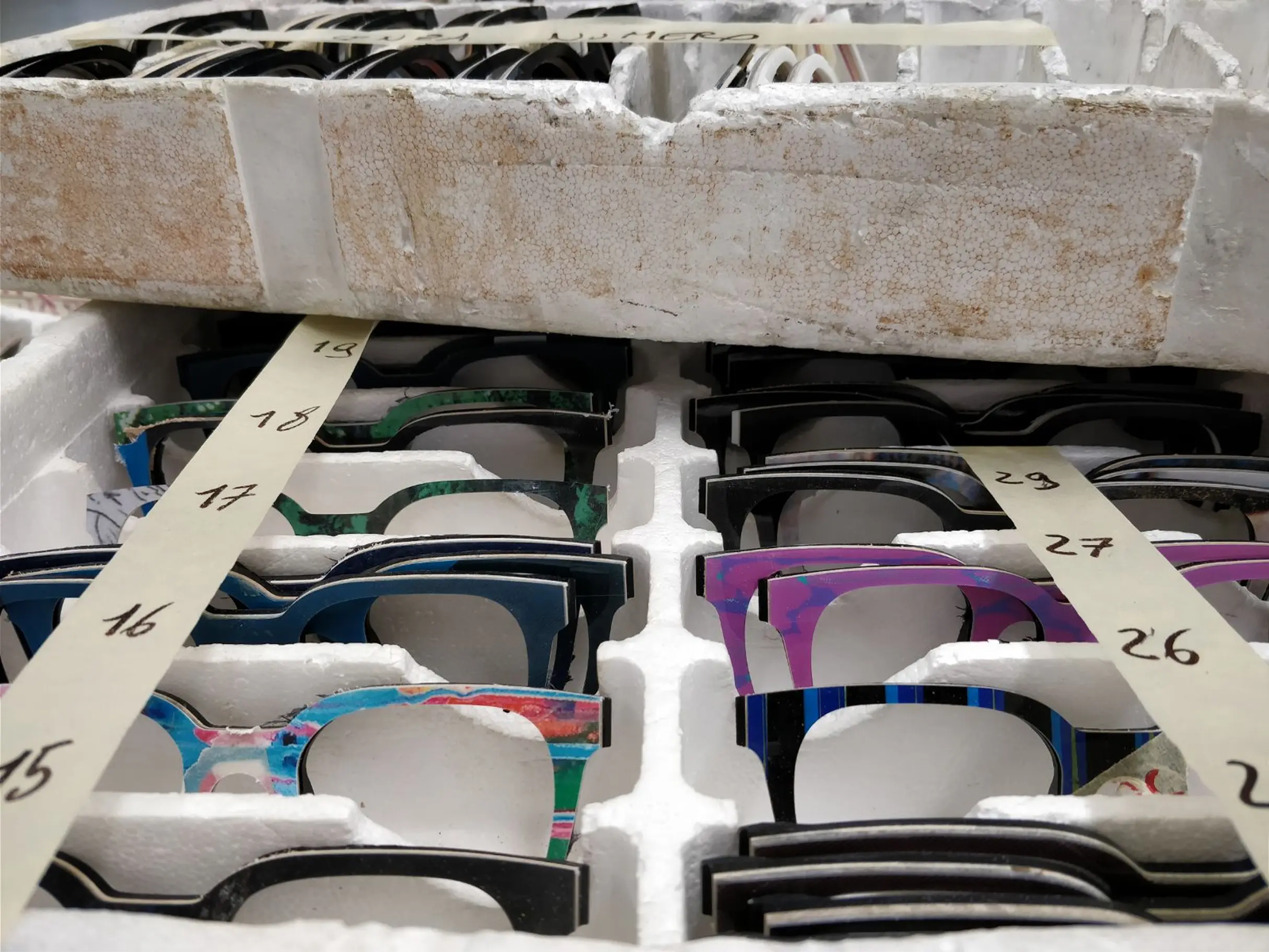 a picture of a eyewear production batch. The glasses are colorful.